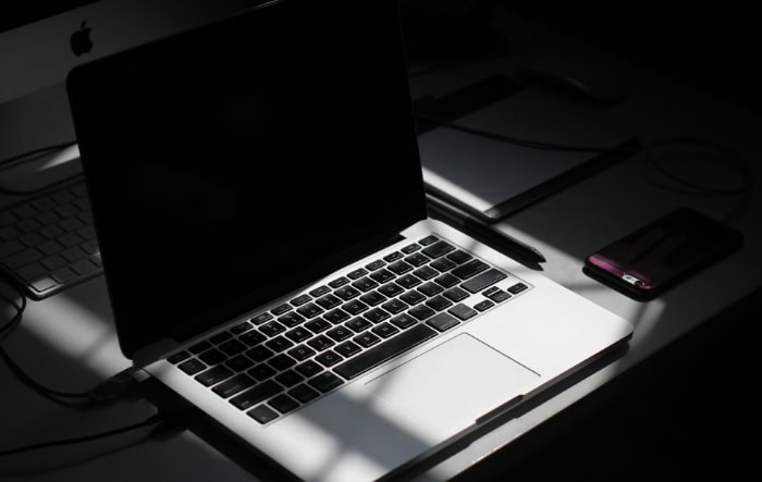 MacBook Pro on desk with dark screen