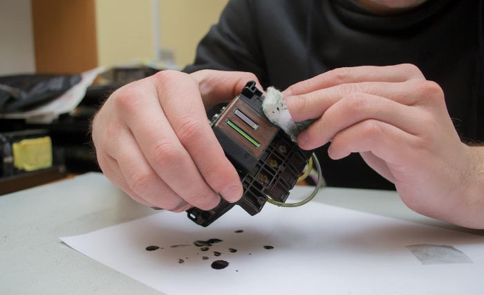 Man cleaning printhead