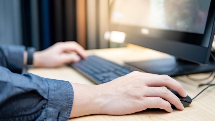 Man clicking on computer mouse