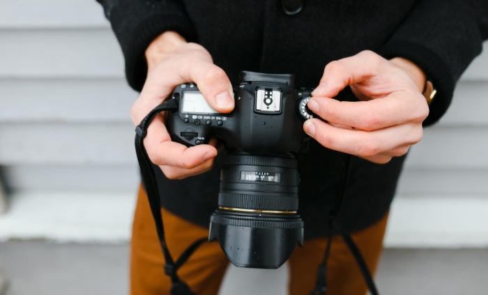 Man holding DSLR camera