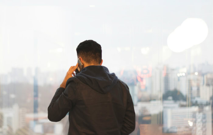 Man making phone call overlooking city