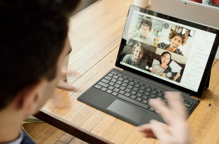 Man participating in a group video call on a tablet