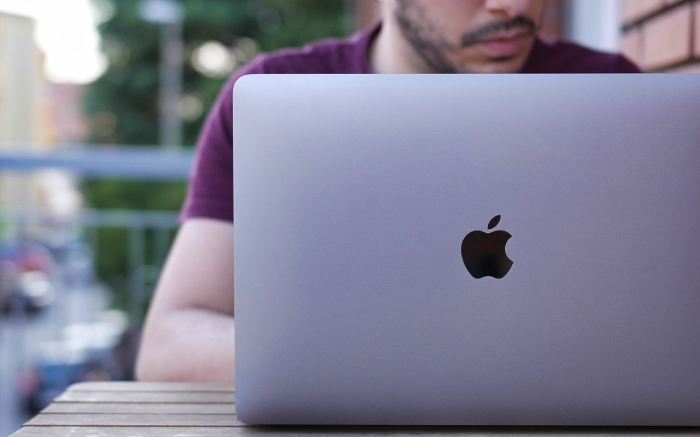 Man using silver macbook