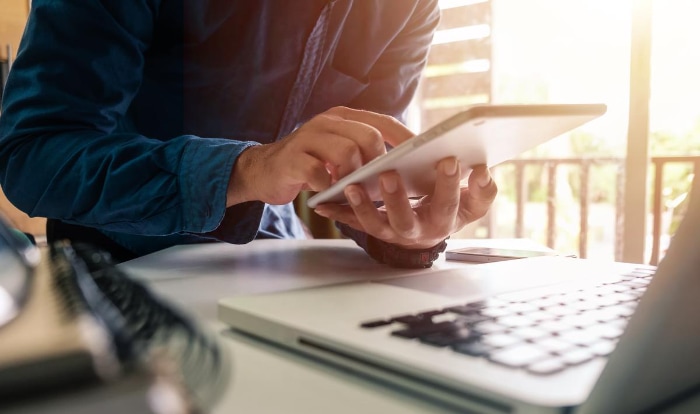 Man using tablet and laptop