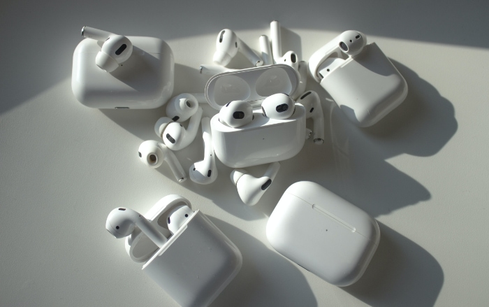 Many AirPods on white table