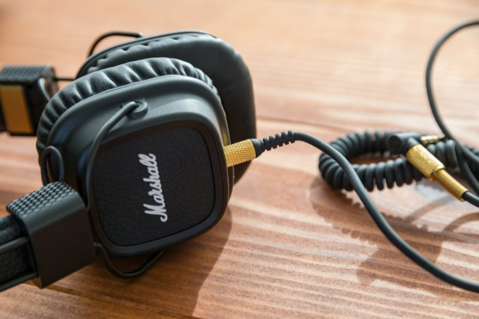 Marshall headphones with coiled audio cable on table
