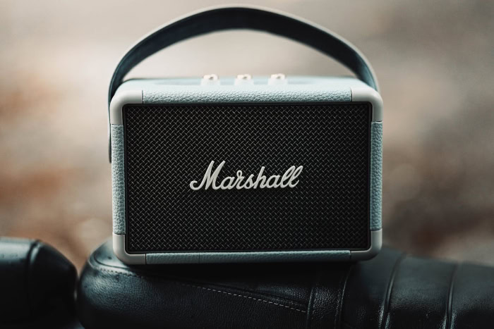 Marshall portable Bluetooth speaker on leather surface