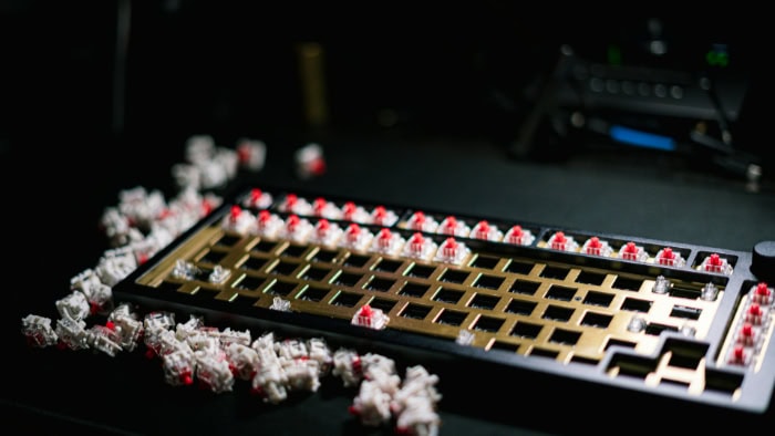 Mechanical keyboard frame with red switches scattered around