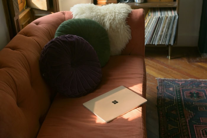 Microsoft Surface laptop on brown leather couch