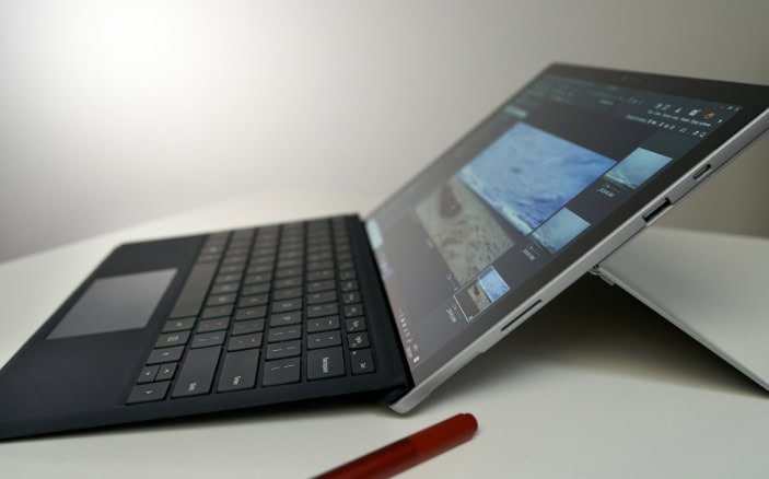 Microsoft Surface tablet in tent mode displaying photo editing software