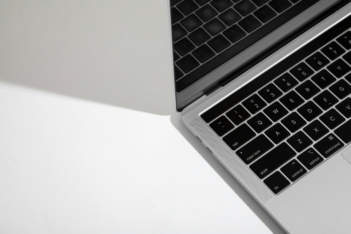 Minimalist silver laptop with keyboard partially visible