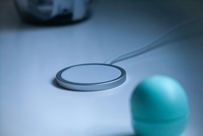 Minimalist wireless charging pad on white surface
