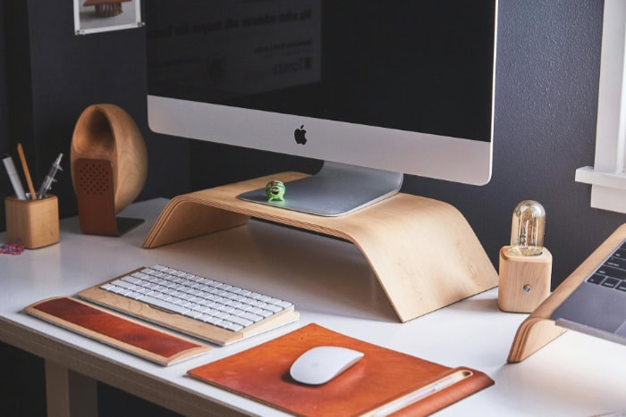 Minimalist workspace with iMac and wooden accessories