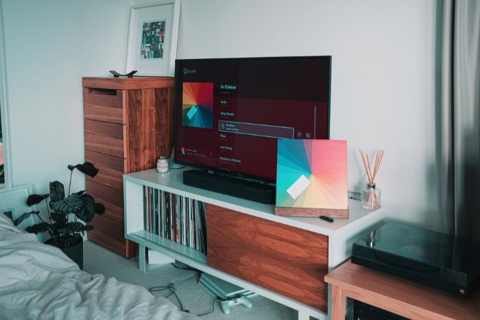 Modern TV setup with Spotify interface and vinyl record