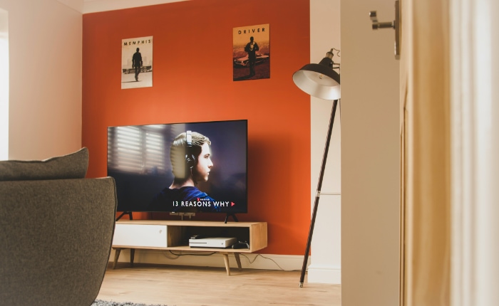 Modern living room with a TV displaying a show