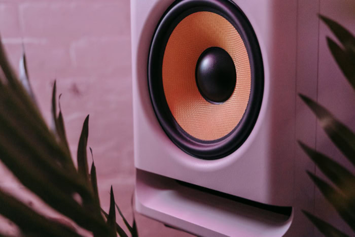 Modern speaker woofer with yellow cone and white casing