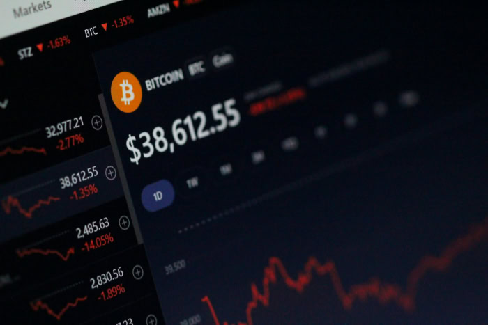 Monitor displaying Bitcoin price and cryptocurrency market statistics