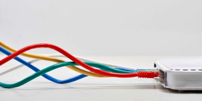 Multicolored Ethernet cables plugged into a router
