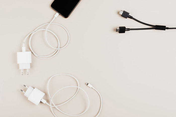 Multiple phone chargers and USB cables flat lay