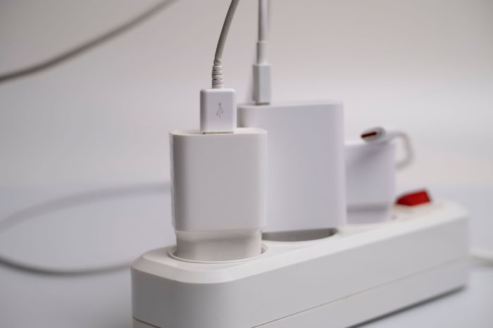 Multiple phone chargers plugged into a power strip