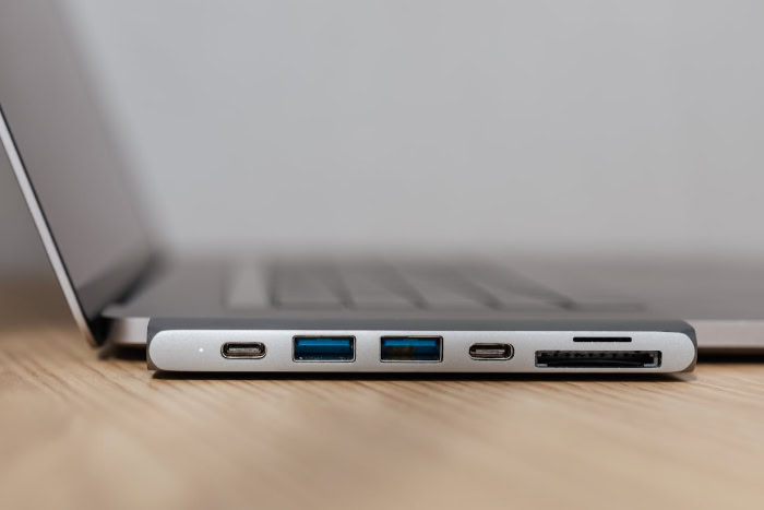 Multiport USB C hub adapter plugged into a laptop