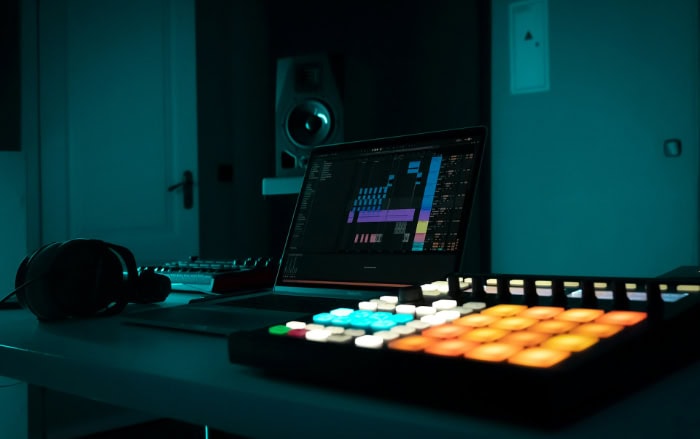 Music production setup with laptop and MIDI controller