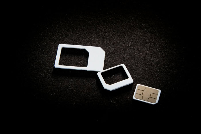 Nano SIM card with white plastic adapters