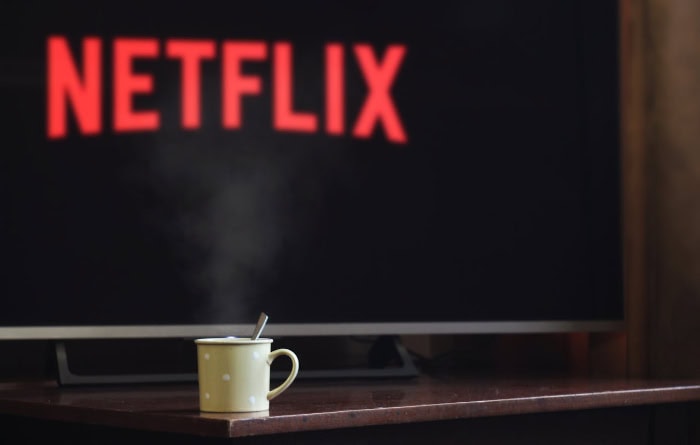 Netflix logo on TV screen with steaming coffee mug