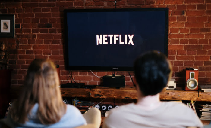 Netflix playing on black smart tv
