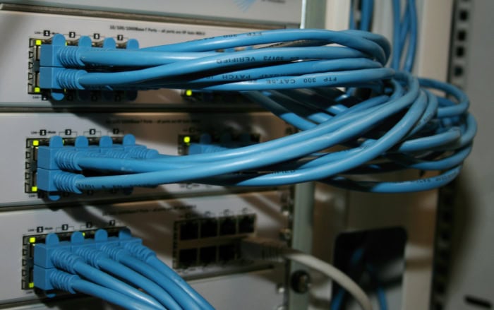 Network rack with blue Ethernet cables connected