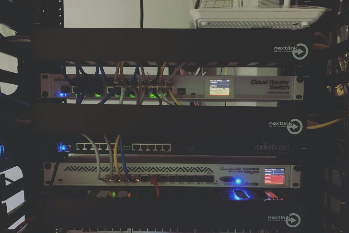 Network rack with routers and switches lit by LED lights