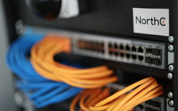 Networking equipment with orange and blue ethernet cables