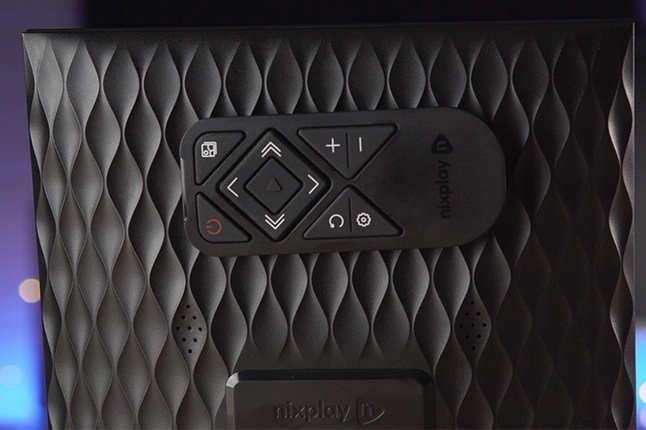 Black remote on Nixplay Smart Digital Picture Frame
