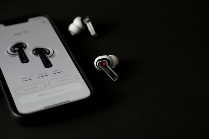 Nothing Ear 1 wireless earbuds next to smartphone