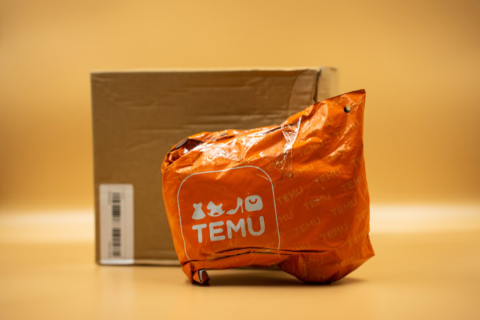 Orange Temu shipping bag and brown cardboard