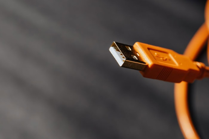 Orange USB cable with a close up of the connector