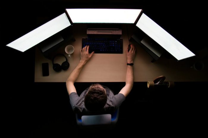 Overhead view of workstation with three computer monitors