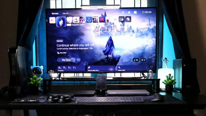 PS5 interface displaying Hogwarts Legacy on a large TV