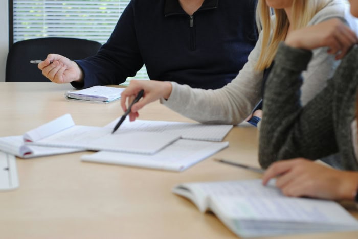 People reviewing documents at meeting table