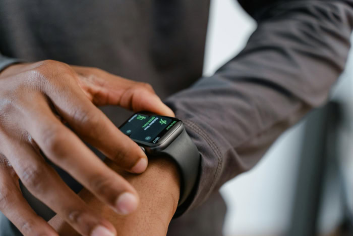 Person adjusting wearable smartwatch