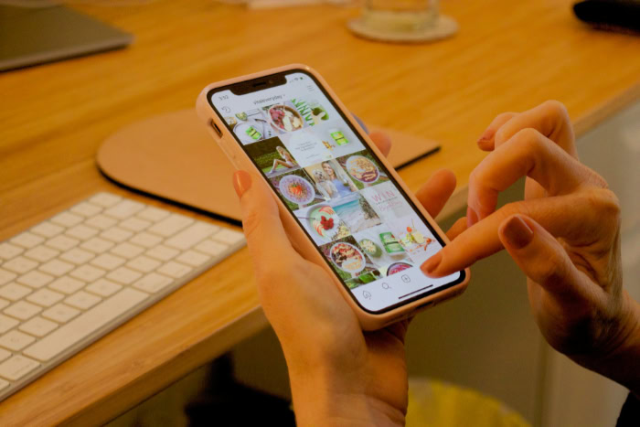Person browsing Instagram feed on mobile phone