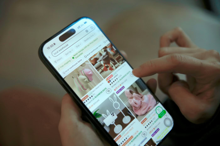 Person browsing retail products on mobile shopping app