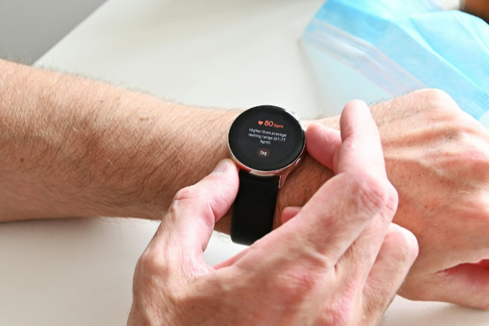 Person checking heart rate on a smartwatch screen