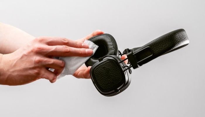 Person cleaning headphones