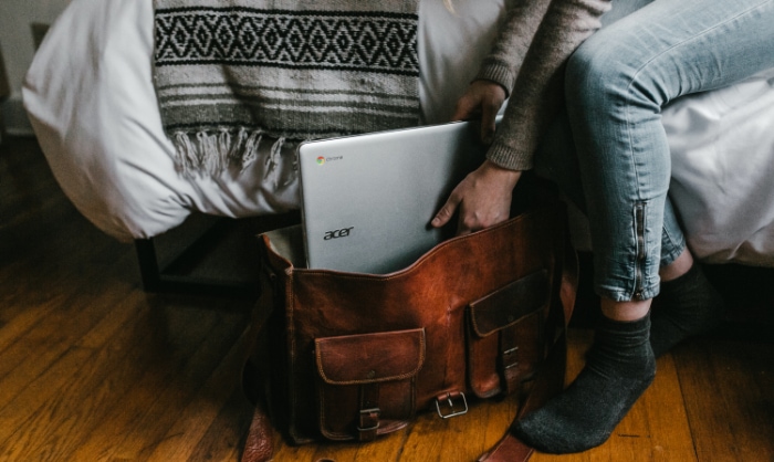 Person holding Chromebook