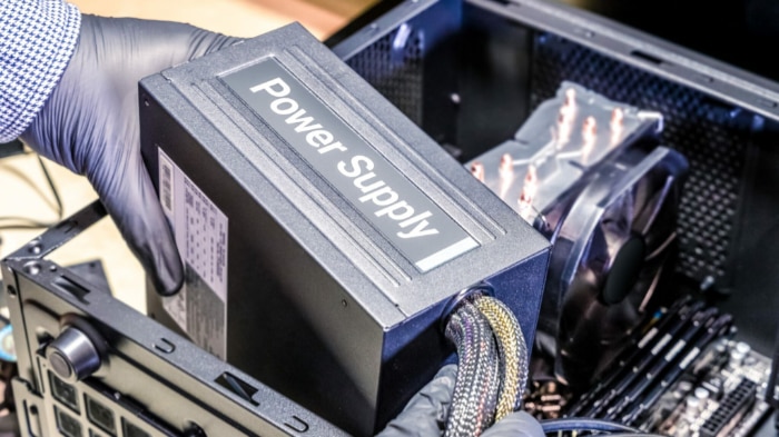 Person holding black power supply unit