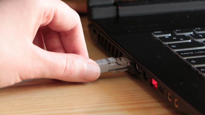 Person holding ethernet cable