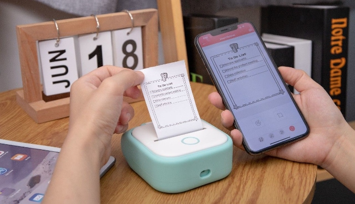 Person holding paper from inkless printer