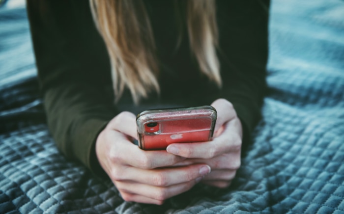 Person holding red iphone