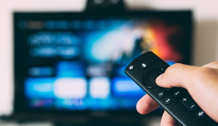 Person holding black remote